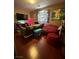 A living room with colorful décor, comfortable seating, and modern flooring at 11457 Steponia Bay St, Las Vegas, NV 89141