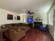 Cozy living room featuring a large sectional sofa, fireplace, and ceiling fan at 11457 Steponia Bay St, Las Vegas, NV 89141
