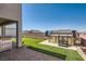 This backyard features a well-maintained lawn, hot tub, stainless steel BBQ, and a brick paver patio at 130 W Fairway Rd, Henderson, NV 89015