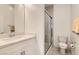 Clean bathroom with quartz countertop vanity, modern sink faucet, and glass door shower at 130 W Fairway Rd, Henderson, NV 89015