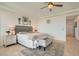 Well-lit bedroom with a gray upholstered bed, a decorative rug, and neutral-toned walls at 130 W Fairway Rd, Henderson, NV 89015