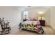 Cozy bedroom with floral bedding, two side tables with lamps, and a rocking chair at 130 W Fairway Rd, Henderson, NV 89015