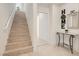 Inviting entryway featuring a staircase, 'HOME' decor, a mirror, and a console table at 130 W Fairway Rd, Henderson, NV 89015