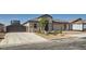 Charming home features a two-car garage and an RV garage, complemented by tasteful stone accents at 130 W Fairway Rd, Henderson, NV 89015