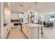 Spacious open kitchen with a large central island, modern appliances, and a nearby dining area at 130 W Fairway Rd, Henderson, NV 89015