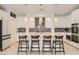 Stylish kitchen featuring stainless steel appliances, a backsplash, and a central island with bar stool seating at 130 W Fairway Rd, Henderson, NV 89015
