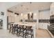 Modern kitchen with a spacious island, stylish pendant lighting, and stainless steel appliances at 130 W Fairway Rd, Henderson, NV 89015