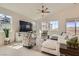 Bright living room featuring vaulted ceilings, large windows, plush seating, and stylish decor at 130 W Fairway Rd, Henderson, NV 89015