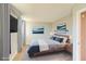 Cozy bedroom featuring neutral walls, carpet flooring, and a comfortable bed with stylish lamps and artwork at 1308 Capri Dr # D, Boulder City, NV 89005
