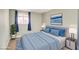 Bedroom featuring a plush bed, stylish decor, and natural light from the window at 1308 Capri Dr # D, Boulder City, NV 89005