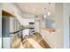 Modern kitchen featuring white cabinets, granite countertops, stainless steel appliances and hardwood floors at 1308 Capri Dr # D, Boulder City, NV 89005