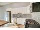 Modern kitchen featuring white cabinets, granite countertops, stainless steel appliances and hardwood floors at 1308 Capri Dr # D, Boulder City, NV 89005