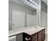 This bathroom features a large mirror, a white sink, dark wood cabinets and a shower/tub at 1405 S Nellis Blvd # 2117, Las Vegas, NV 89104