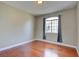 The bedroom offers hardwood flooring, a neutral color scheme, and a window with outdoor views at 1405 S Nellis Blvd # 2117, Las Vegas, NV 89104