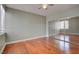Spacious bedroom with hardwood floors, ceiling fan, large window, and a mirrored closet at 1405 S Nellis Blvd # 2117, Las Vegas, NV 89104