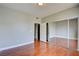 Bedroom features hardwood floors, large mirrored closet doors, and light-colored walls at 1405 S Nellis Blvd # 2117, Las Vegas, NV 89104