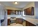 Kitchen features stainless steel appliances, dark wood cabinets, and white tile countertops at 1405 S Nellis Blvd # 2117, Las Vegas, NV 89104
