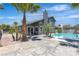 Backyard featuring concrete, a pool, grass, palm trees, and a gray house at 1638 Candice St, Las Vegas, NV 89156