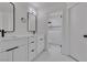 Modern bathroom featuring double sinks, white marble countertops, and sleek black fixtures at 1638 Candice St, Las Vegas, NV 89156