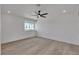 Bright bedroom with neutral walls, wood floors, ceiling fan, and sunlit window at 1638 Candice St, Las Vegas, NV 89156