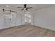 Spacious bedroom featuring wood floors, ceiling fan, and access to the rest of the home at 1638 Candice St, Las Vegas, NV 89156
