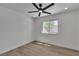Bright bedroom with a ceiling fan and window overlooking the backyard at 1638 Candice St, Las Vegas, NV 89156
