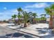 Charming single-story home featuring mature palm trees and a well-maintained front yard at 1638 Candice St, Las Vegas, NV 89156