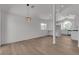 Spacious home with a view of an open white kitchen, new wood floors, and modern lighting fixture at 1638 Candice St, Las Vegas, NV 89156
