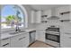 Upgraded kitchen featuring stainless steel appliances, marble countertops, and open shelving at 1638 Candice St, Las Vegas, NV 89156