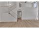 Bright living room featuring a staircase with white railing and light wood floors at 1638 Candice St, Las Vegas, NV 89156