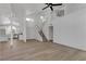 A stylish living room flows into the kitchen, featuring new wood floors and a staircase leading to the loft at 1638 Candice St, Las Vegas, NV 89156