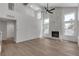The cozy living area features a striking stone fireplace, wood floors, and bright natural light at 1638 Candice St, Las Vegas, NV 89156
