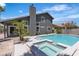 Backyard view of a pool and spa with a grey two-story home in the background at 1638 Candice St, Las Vegas, NV 89156