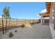 This backyard has desert landscaping, a black iron fence for views, and a covered patio for enjoying the tranquil landscape at 164 Cabo Cruces Dr, Henderson, NV 89011