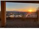 This is the view of the mountain sunset from the home's covered brick patio, set against desert landscaping and black iron fence at 164 Cabo Cruces Dr, Henderson, NV 89011