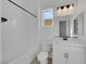 Bright bathroom featuring a combination tub and shower, white vanity, toilet and ample lighting for convenience at 164 Cabo Cruces Dr, Henderson, NV 89011