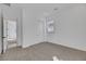 Neutral bedroom featuring plush carpet, white walls, a window, and a closet, with an open doorway at 164 Cabo Cruces Dr, Henderson, NV 89011