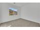 Minimalist bedroom design with plush carpet and a bright window view, creating a serene and inviting atmosphere at 164 Cabo Cruces Dr, Henderson, NV 89011