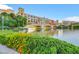 Scenic bridge over a lake with colorful buildings, manicured landscaping, and architectural detail at 164 Cabo Cruces Dr, Henderson, NV 89011