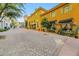 Charming yellow buildings housing boutiques line a brick-paved street with appealing architectural details at 164 Cabo Cruces Dr, Henderson, NV 89011