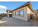 The exterior of this home offers desert landscaping, a covered patio, neutral colored stucco and dark trim around the windows at 164 Cabo Cruces Dr, Henderson, NV 89011
