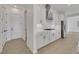 Stylish kitchen boasts stainless steel appliances, white cabinets, and quartz countertops at 164 Cabo Cruces Dr, Henderson, NV 89011