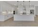 Bright, open kitchen with white cabinetry, marble countertops, and a large center island at 164 Cabo Cruces Dr, Henderson, NV 89011