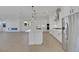 Modern white kitchen features an island, stainless steel appliances, and sleek pendant lighting at 164 Cabo Cruces Dr, Henderson, NV 89011