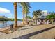 Picturesque lakefront boardwalk with palm trees, quaint shops, and scenic water views in a vibrant community at 164 Cabo Cruces Dr, Henderson, NV 89011
