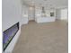 Open-concept living area with a stylish fireplace and direct view of the modern kitchen with bar seating at 164 Cabo Cruces Dr, Henderson, NV 89011