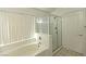 Bathroom with a bathtub and a glass enclosed shower at 1721 Mill Canyon Dr, Las Vegas, NV 89128
