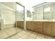 Bathroom featuring a double vanity, mirror, bathtub, and separate glass-enclosed shower at 1721 Mill Canyon Dr, Las Vegas, NV 89128