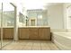 Large bathroom featuring a double vanity, large mirror, bathtub, and glass-enclosed shower at 1721 Mill Canyon Dr, Las Vegas, NV 89128