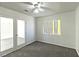 Bedroom with plush carpet, ceiling fan, natural light, and glass paneled doors at 1721 Mill Canyon Dr, Las Vegas, NV 89128